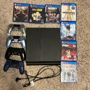 PlayStation 4 with games and controllers